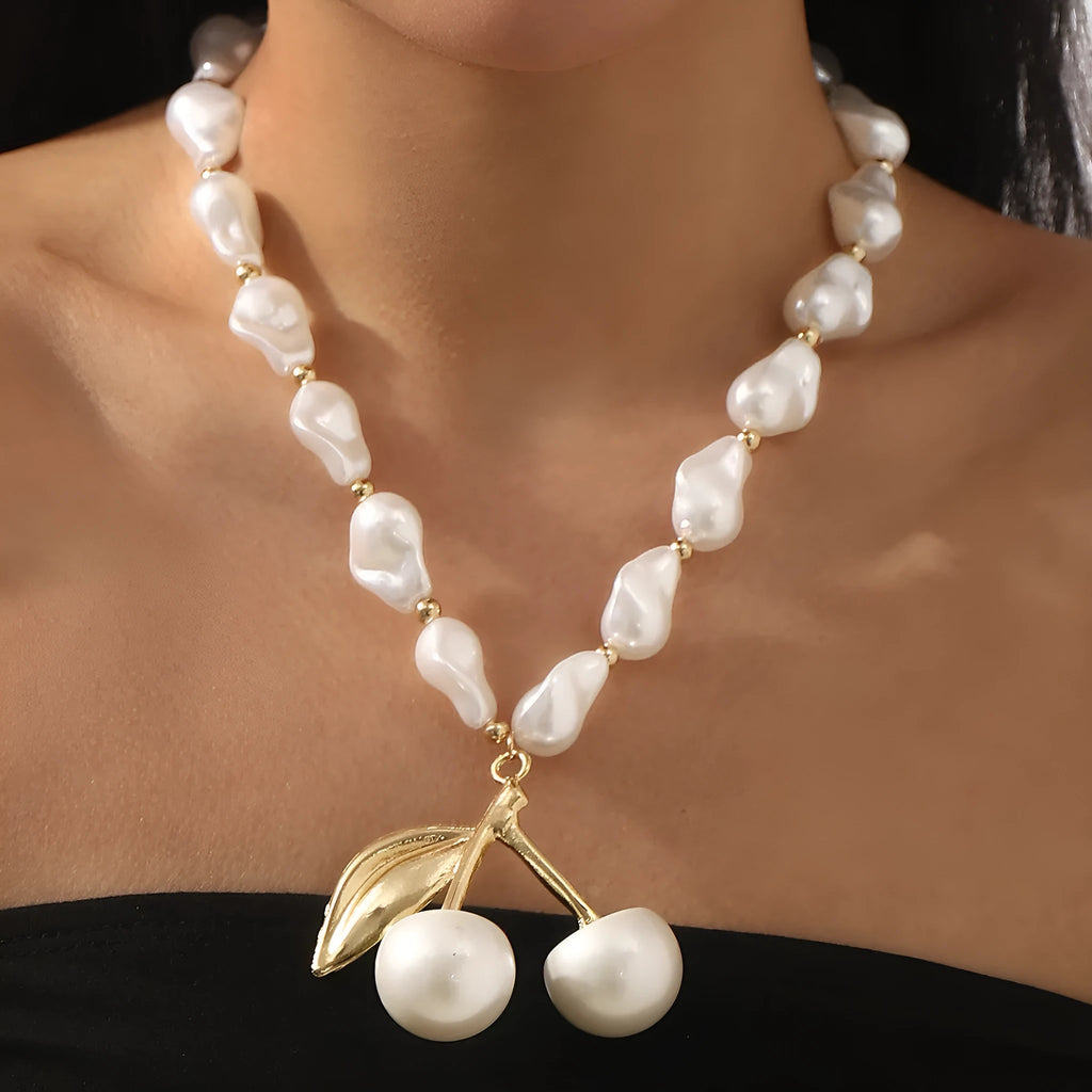Women's gold and white necklace with cherry fruit and pearl pendant on an adjustable chain