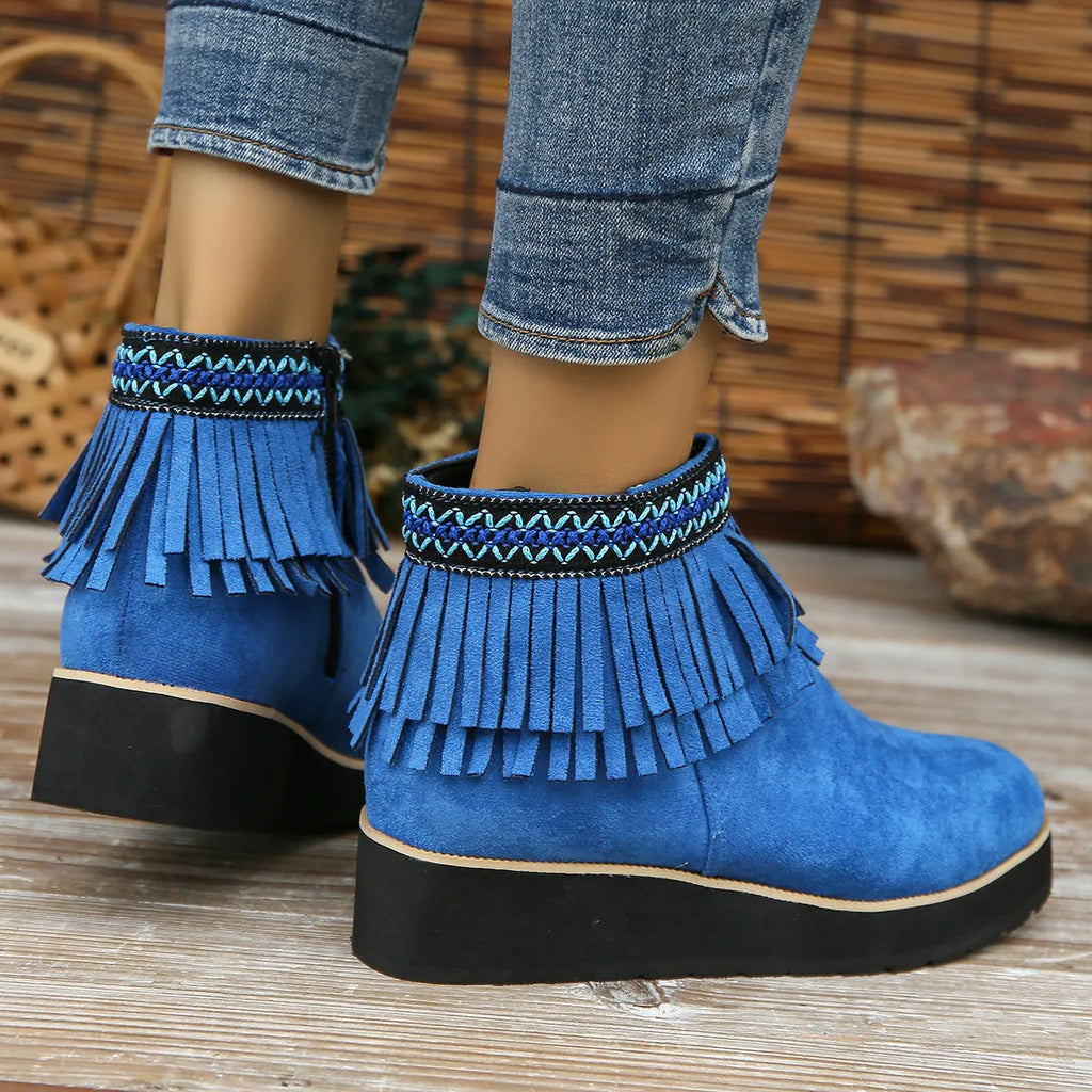 Women's dark brown suede wedge ankle boots with a side zipper and decorative tassels.