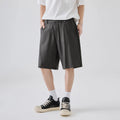 A man wearing loose-fit apricot casual shorts made from a cotton blend fabric.
