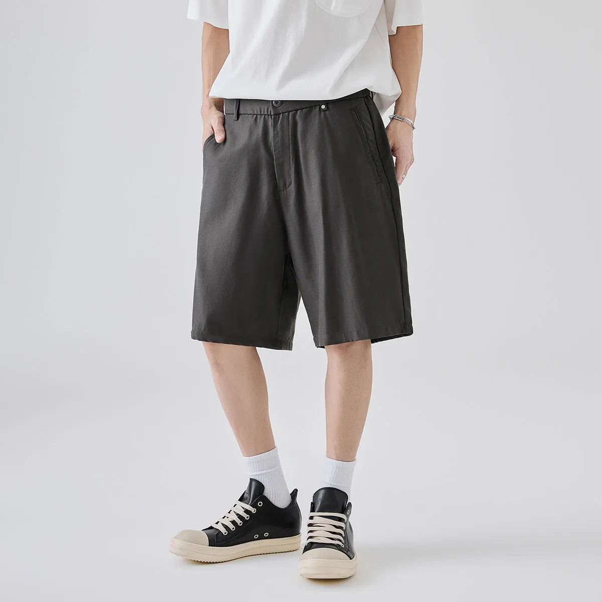 A man wearing loose-fit apricot casual shorts made from a cotton blend fabric.