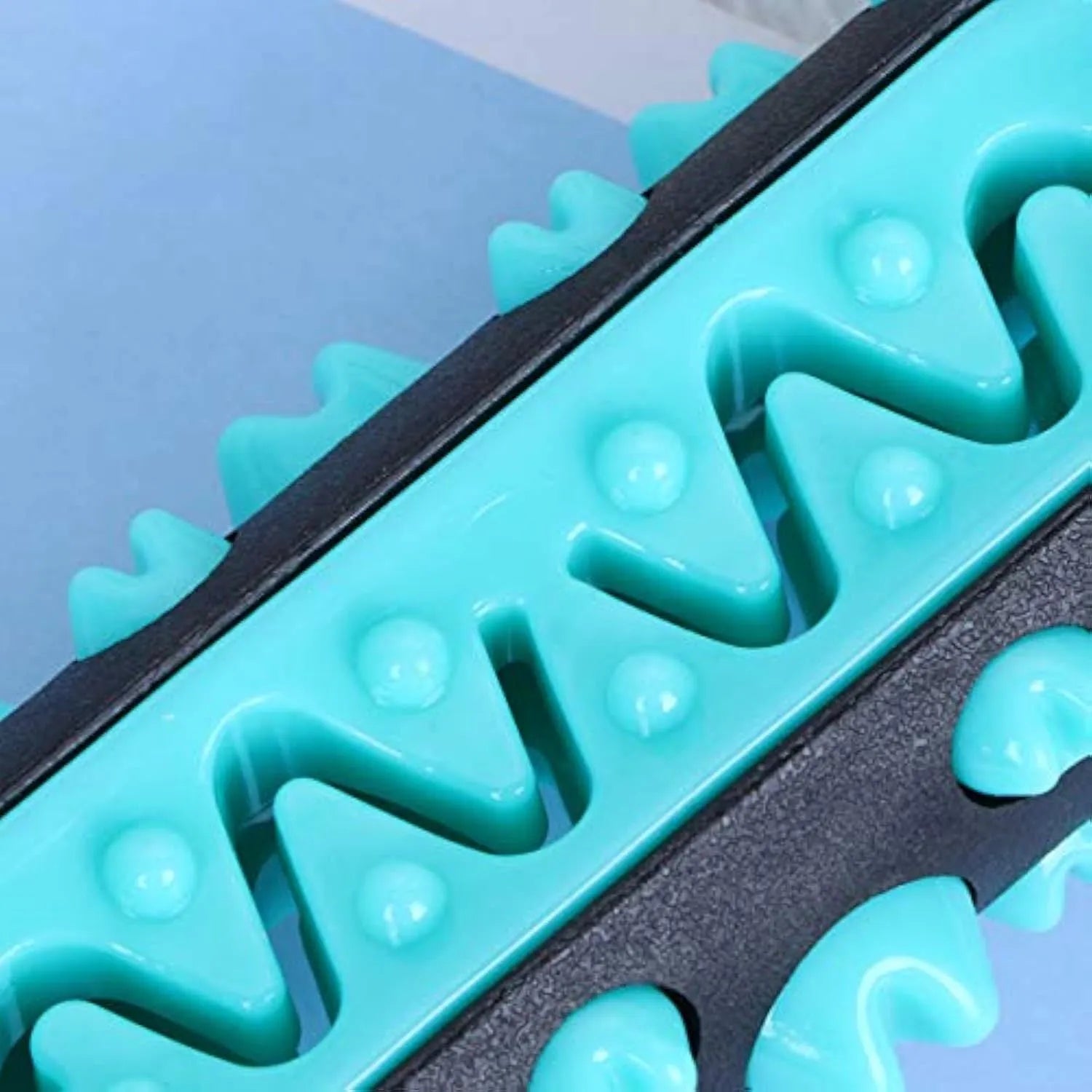 Natural rubber dog toothbrush chew toy in blue with cleaning bristles, shown next to a size scale.