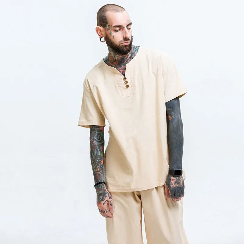 Man wearing a loose apricot coloured cotton short sleeve T-shirt.