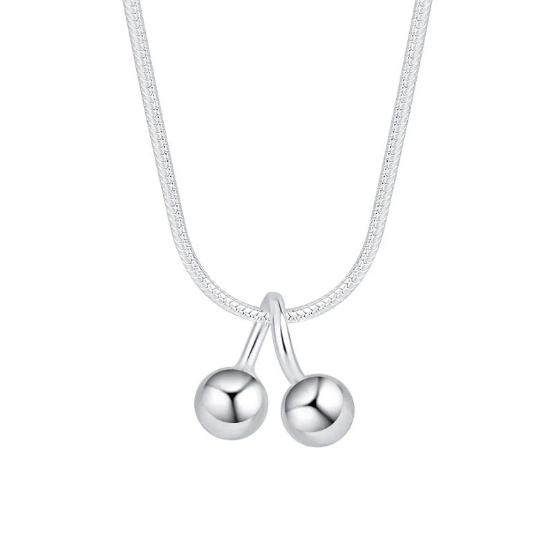 925 silver cherry pendant necklace with an adjustable snake bones chain on a white background.