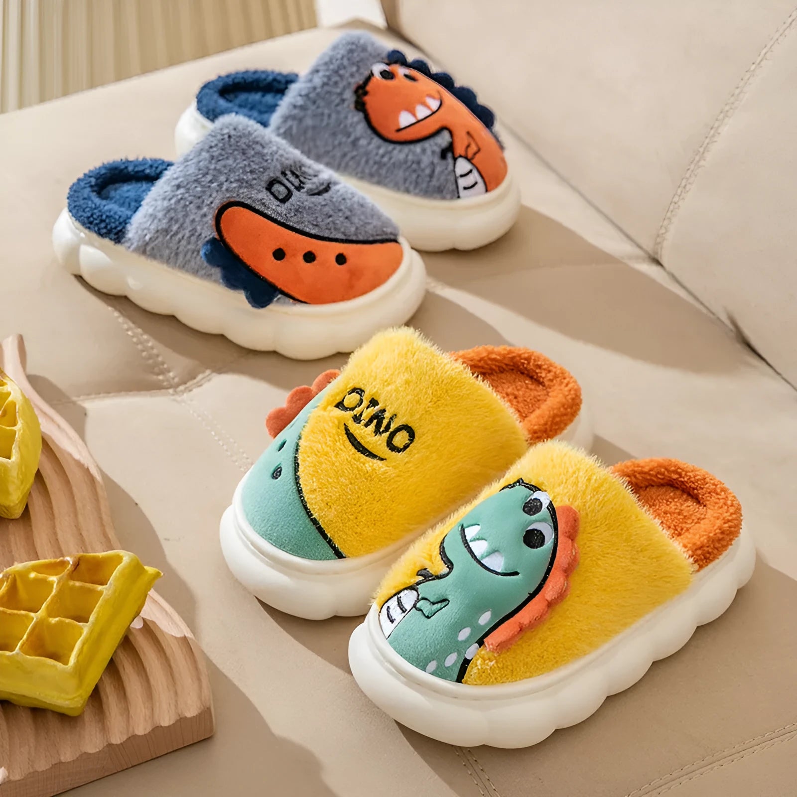 A pair of warm plush cotton slippers for couples, shown in a dinosaur-themed colour design.