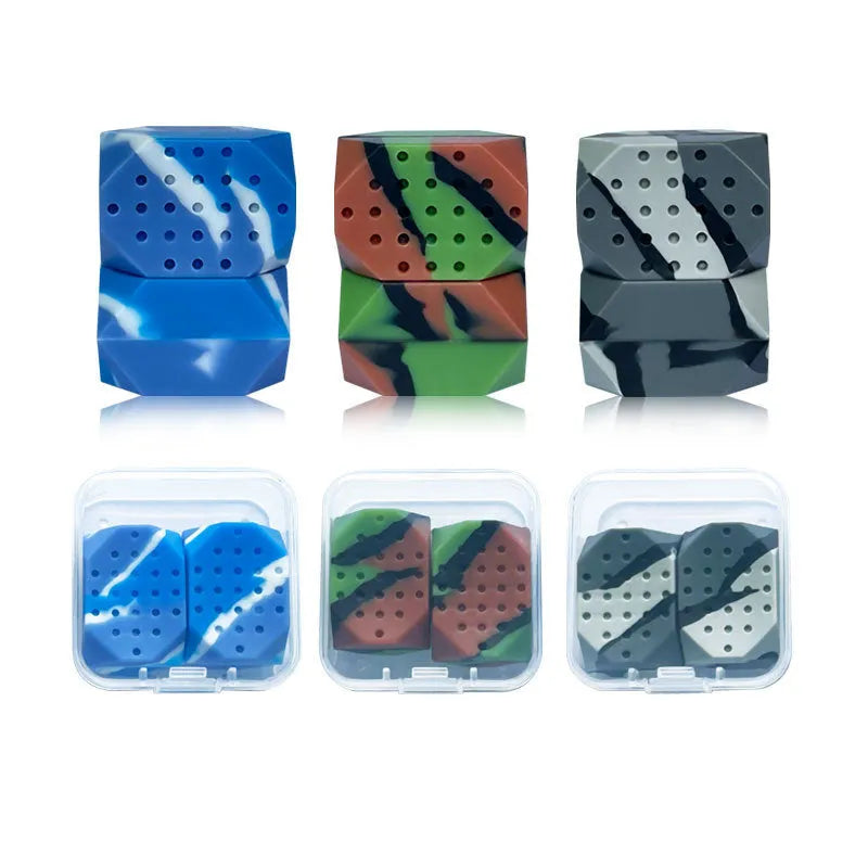 Two camouflage silicone facial muscle fitness balls for jaw training in a transparent box.