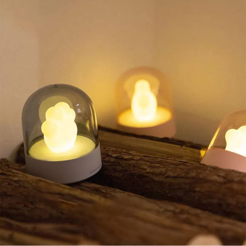 Grey cat paw USB charging music box night light with adjustable brightness on wooden desk
