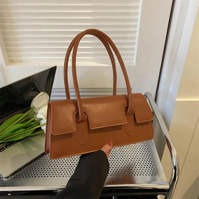 Women's small square shoulder bag in PU leather showing document compartment interior and stitching detail