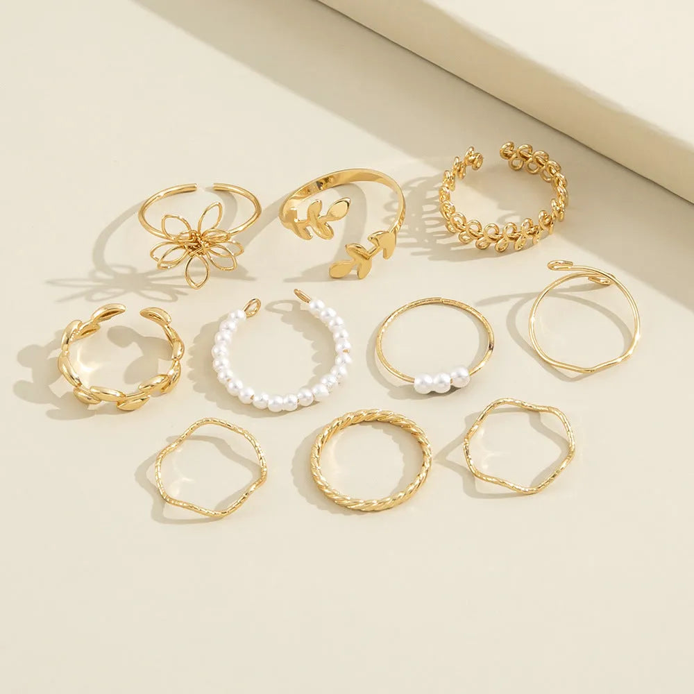 Gold-coloured openwork flower ring made from alloy with a glossy electroplated finish.