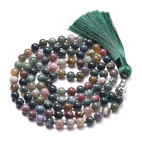 Long blue gemstone tassel necklace with agate, lapis lazuli, and turquoise beads on a geometric pendant.