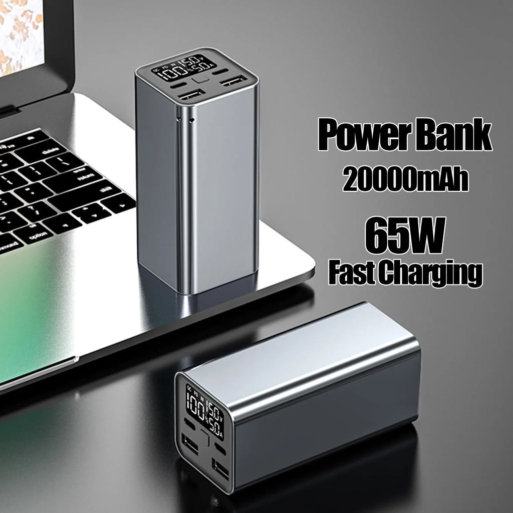 A black metal 65W laptop power bank with 20000mAh capacity, showing size compared to a hand.