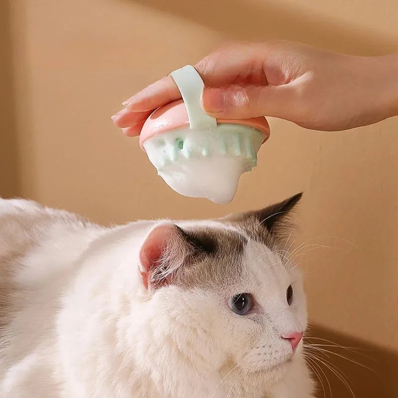Blue silicone pet bathing brush with soft bristles and ergonomic handle for cats and dogs.