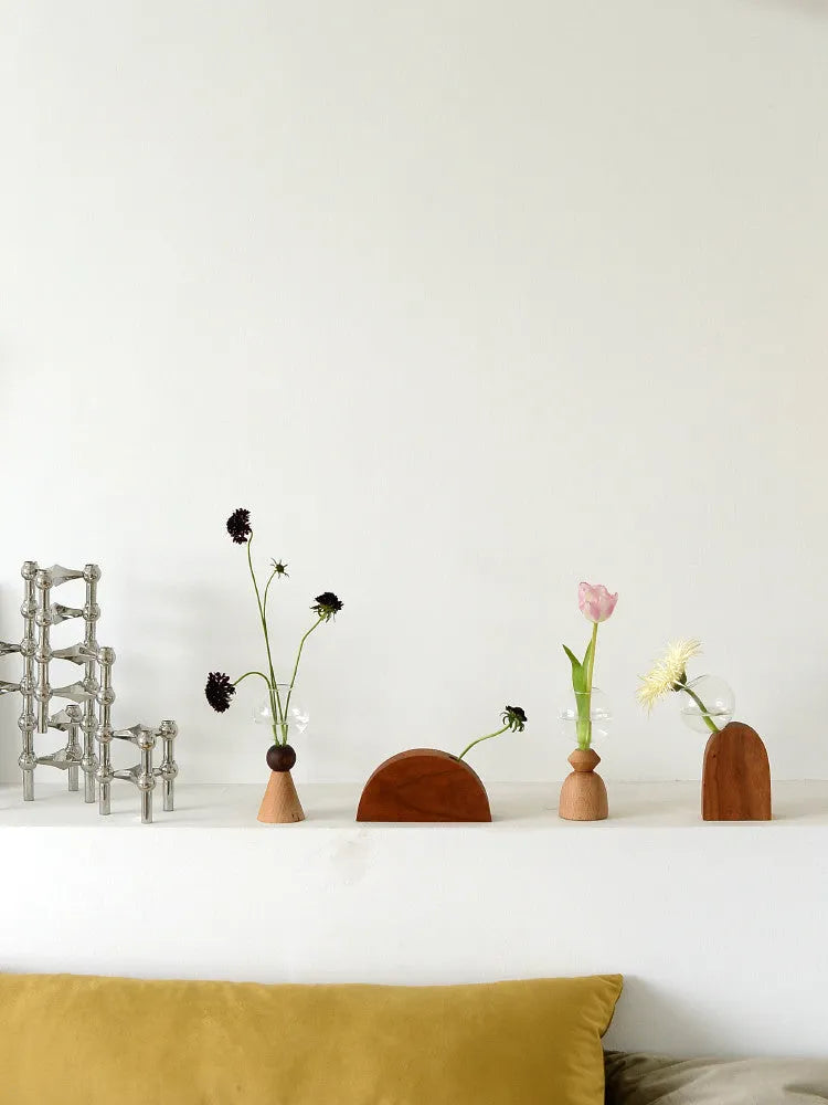 Clear glass Nordic geometric bubble vase with choice of conical base or curved arc base on a wooden table.