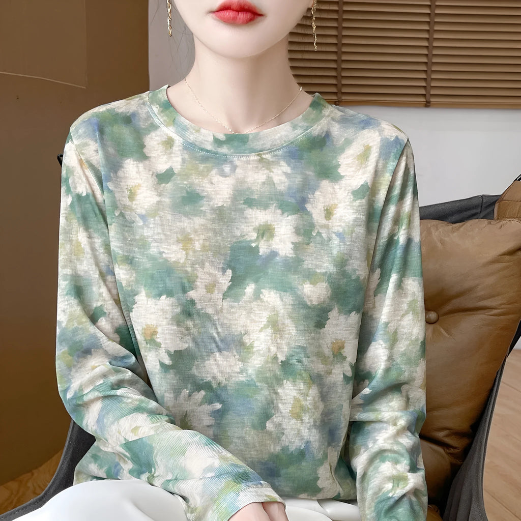 Round neck Tencel cotton pullover shirt with a colourful floral print, shown on a hanger.