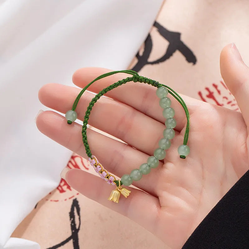 Hand woven red rope bracelet with floral design elements in Lily Carrying Strap colour