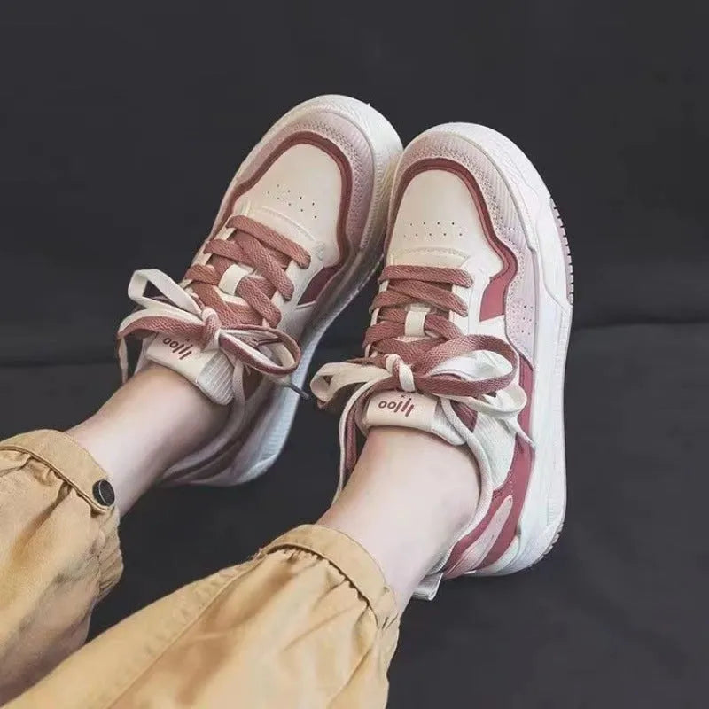 Women's beige and pink low-top rubber sole sneakers on a white background