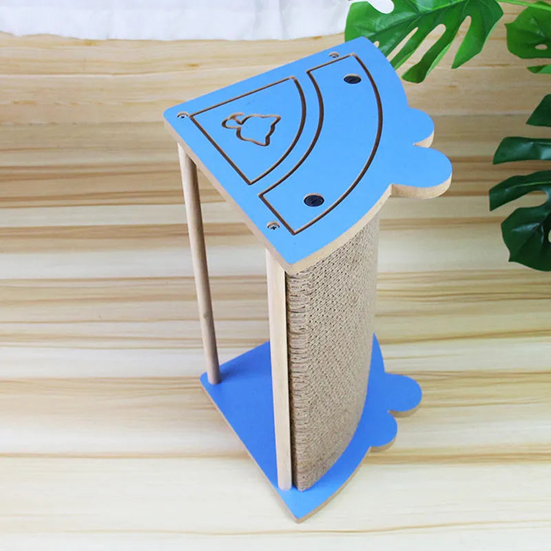 Grey corner-shaped cardboard cat scratching post with a white hanging ball, shown placed in a room corner.