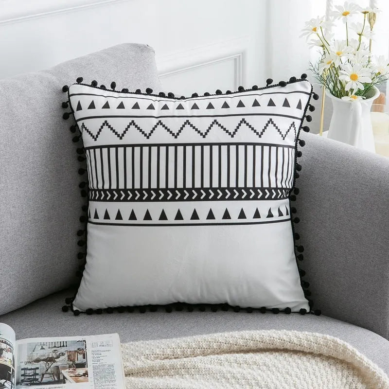 Bohemian national style throw pillow cushion cover in light grey on a sofa.