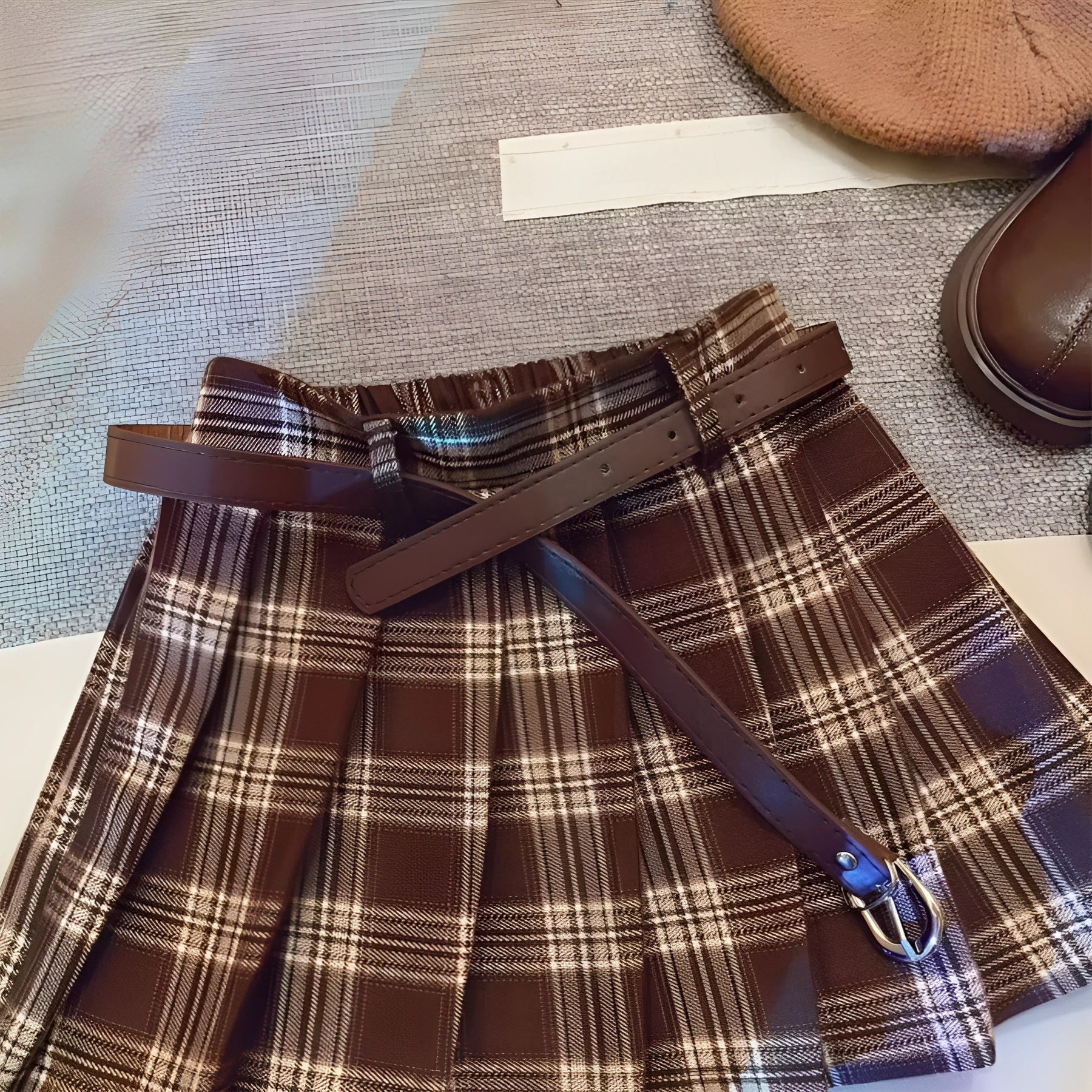 Girls red and black plaid A-line pleated skirt made from cotton blend fabric.