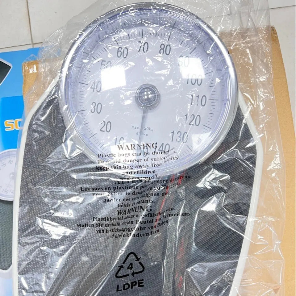 Black mechanical body weight scale with large analogue dial showing pointer display.