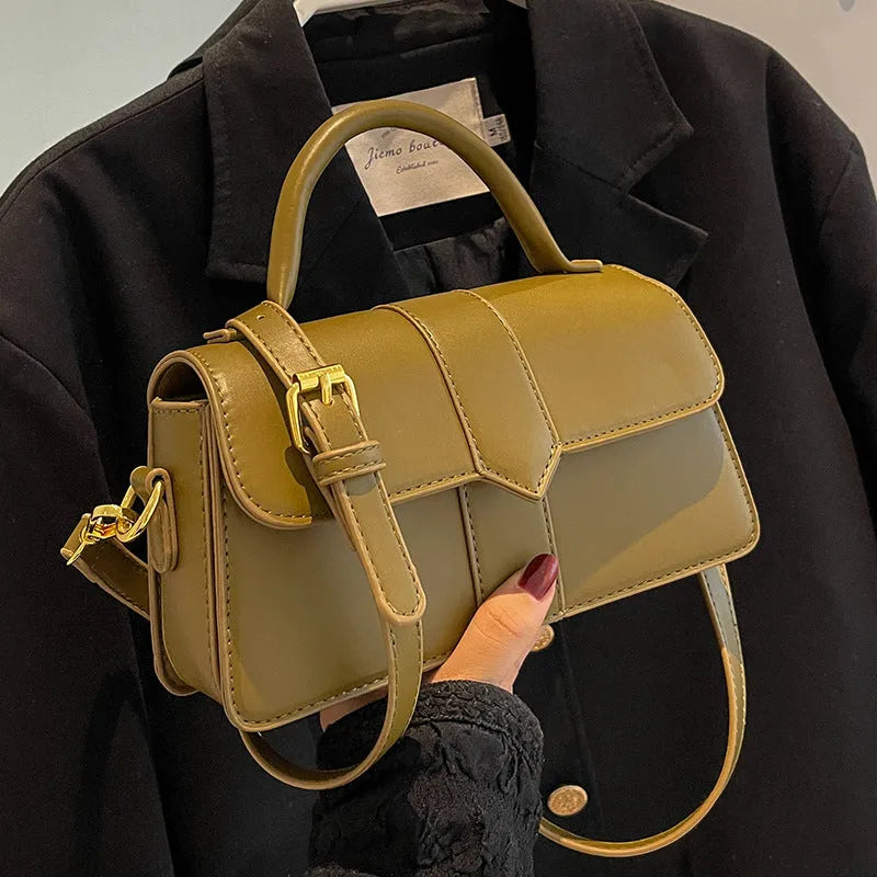 Beige women's square messenger bag with a top handle and shoulder strap, showing an outer pocket.
