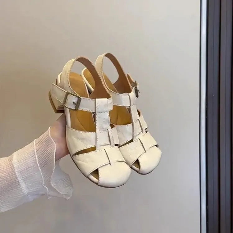 Women's apricot buckle shoes with round toe, two-layer cowhide upper, and rubber sole on a plain background