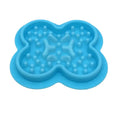 Silicone pet licking mat slow feeder in assorted colours on a floor