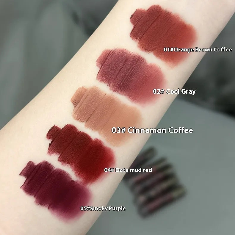 Matte lip mud lipstick tube in one of five shades: orange brown coffee, cool grey, cinnamon coffee, jujube red, or smoked purple.