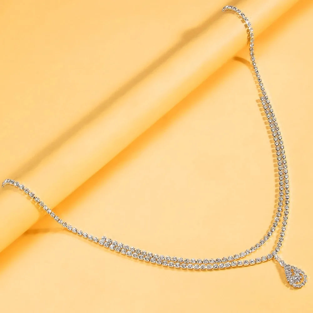 Gold or silver rhinestone waist chain with tassel detail and lobster buckle fastening