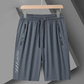 Man wearing black loose-fit quick-dry nylon sports shorts.
