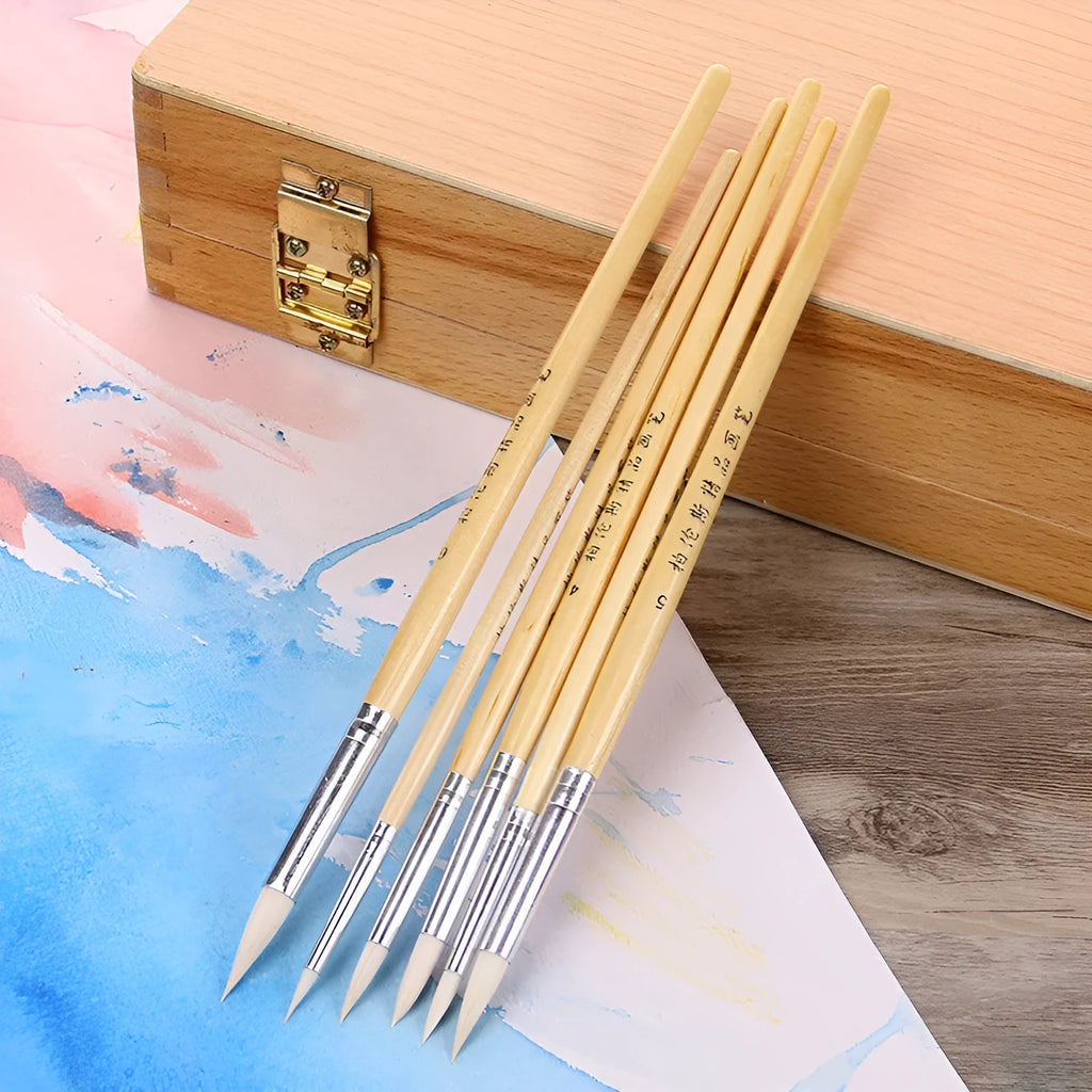 Set of six wooden-handled artist pen brushes with pointed tips on a white background.