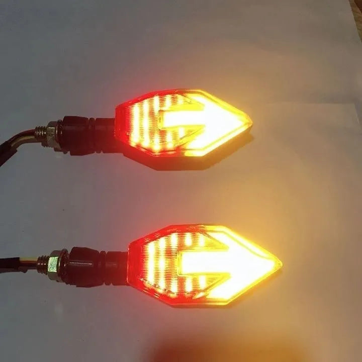 Arrow-shaped 12V LED motorcycle turn signal light in yellow with choice of blue, red, or white accent.