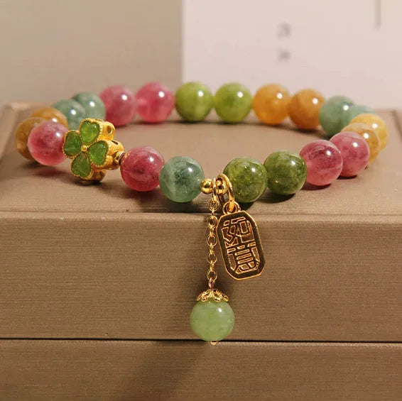Women's colourful tourmaline bracelet with four-leaf clover charm and pearl pendant on a mixed material electroplated chain.