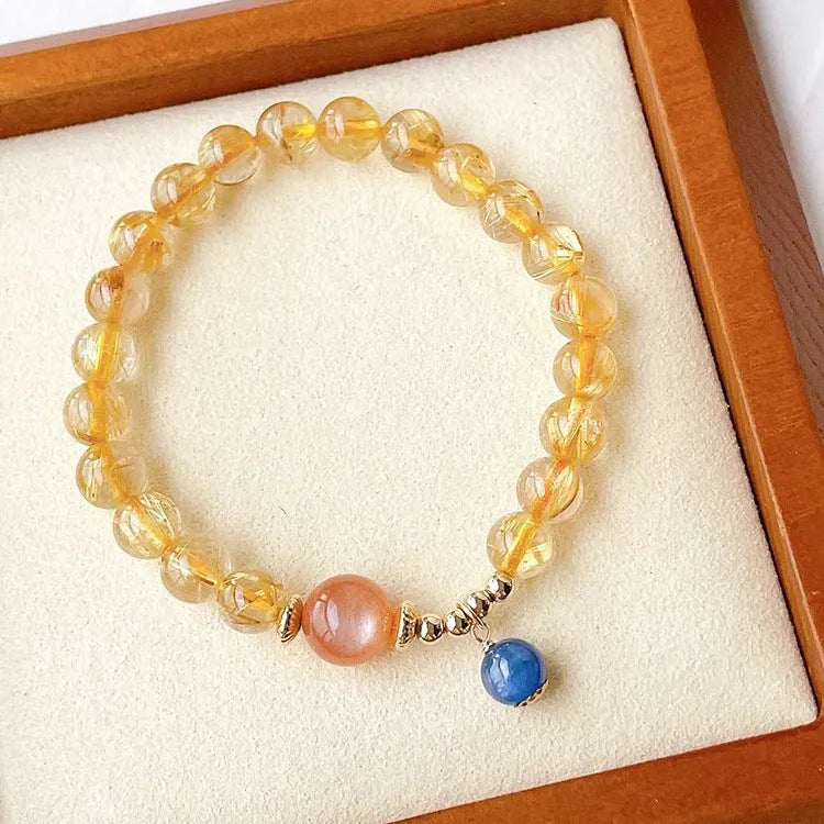 Gold rutilated quartz sunstone crystal bracelet with diamond-shaped beads for women.