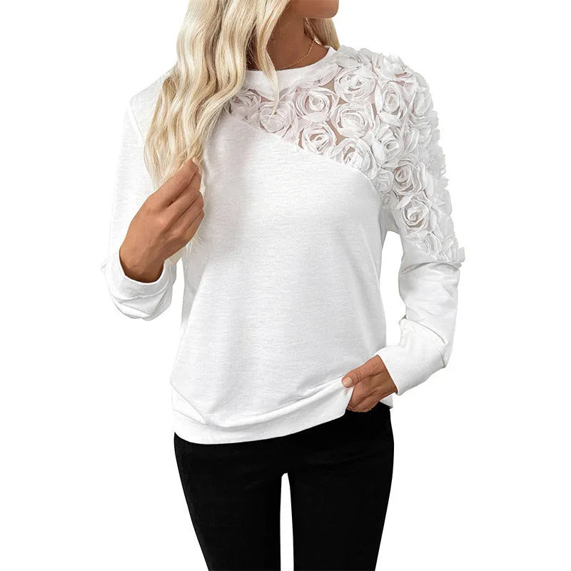 White long sleeve women's top with floral pattern, loose fit.