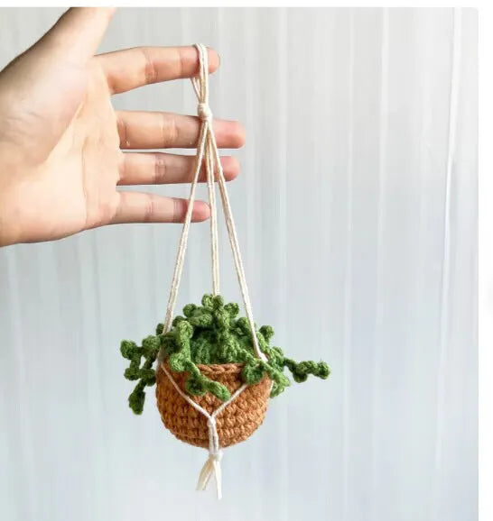 Green and white knitted wool car plant decoration with 8cm base and hanging rope.