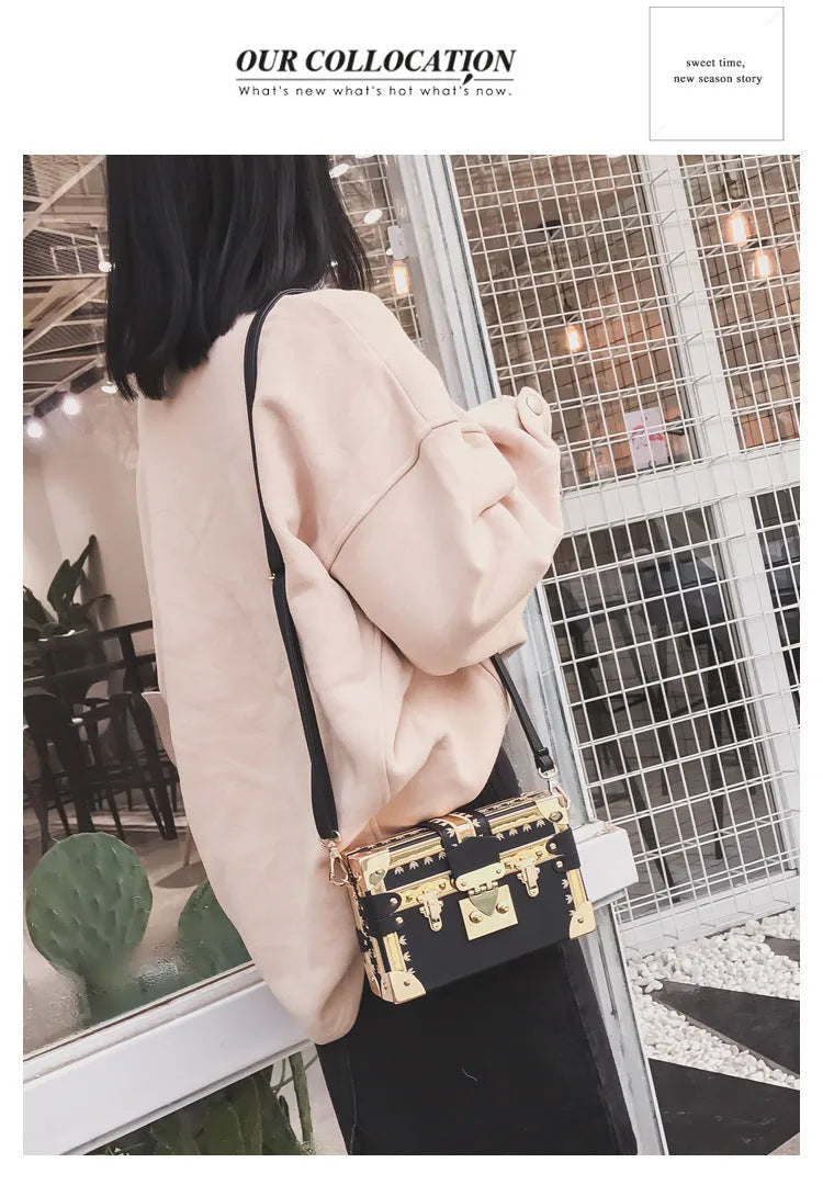 Black hard shell women's shoulder bag with a flap and crossbody strap
