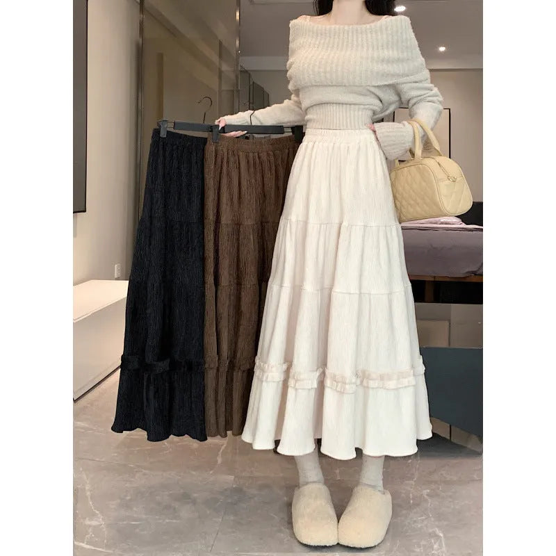 Korean style beige corduroy A-line midi skirt with elastic waistband on a hanger.