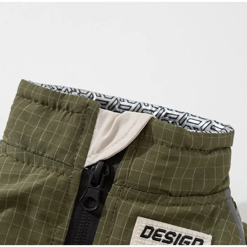 Khaki plaid and beige padded dog windbreaker with built-in leash ring and zipper pocket