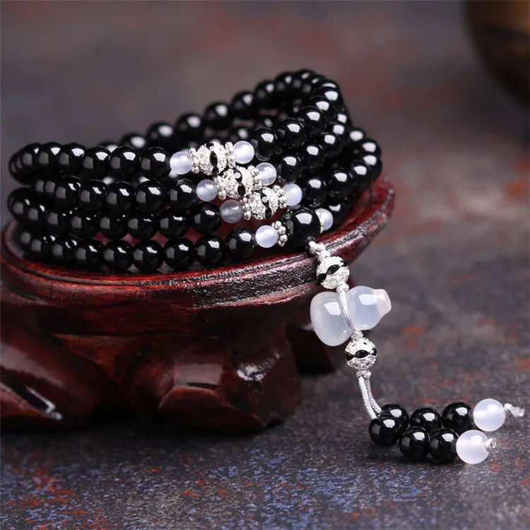 Black agate 108 bead unisex geometric bracelet with number elements.