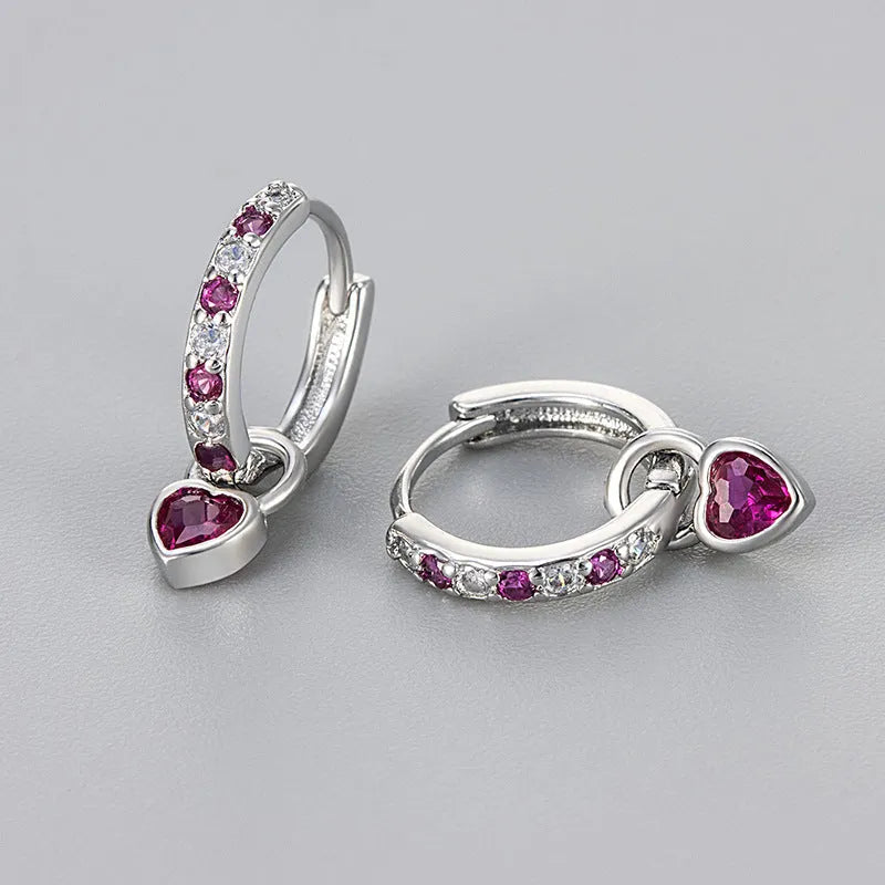 Women's heart-shaped drop earring with a dangling coloured stone, available in gold or white gold plating.