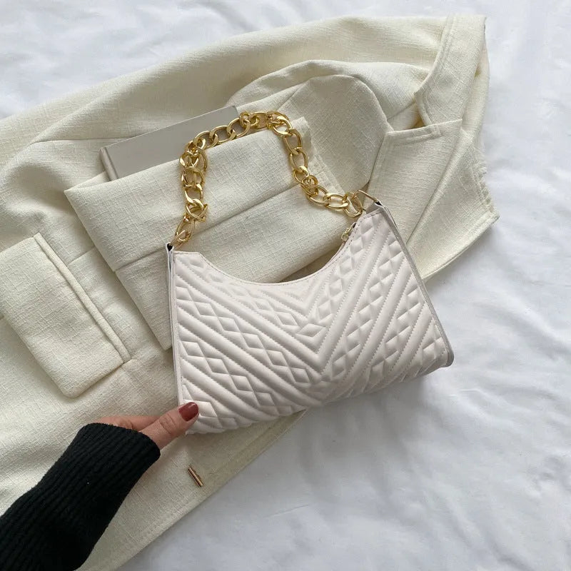 Brown pleated chain baguette shoulder bag showing vertical square shape and soft carry handle