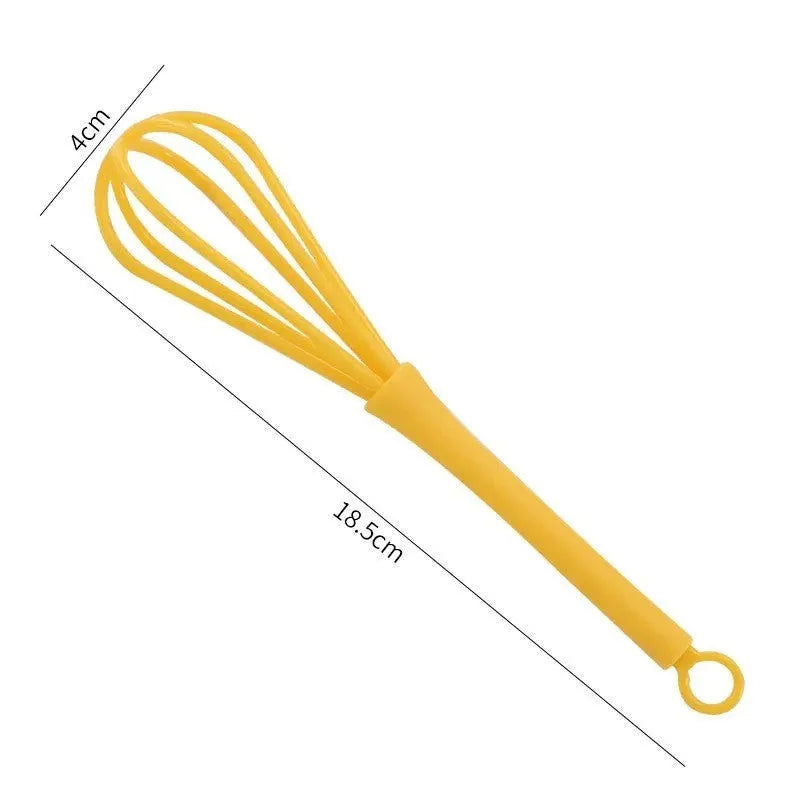 Plastic creative mini manual eggbeater in green and yellow, size 4x18.5 cm, on kitchen counter