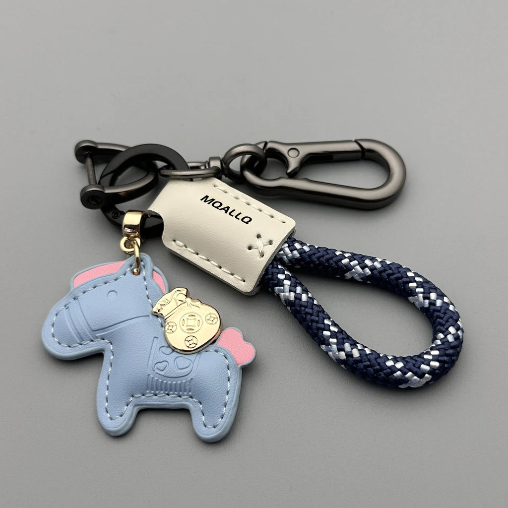 Handmade brown cowhide key ring pendant with a zinc alloy pony buckle on a green flanelle rope.