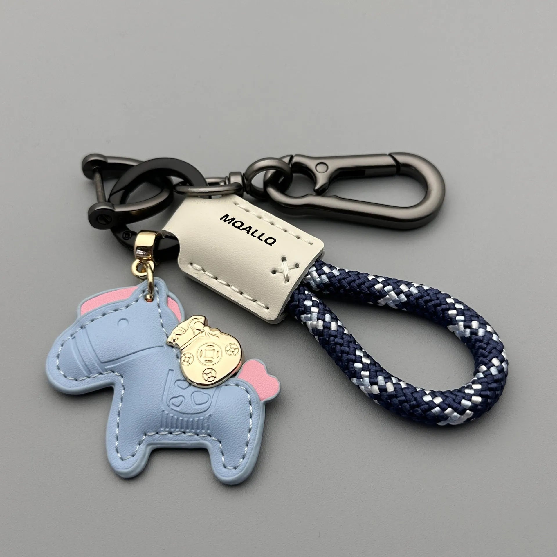 Handmade brown cowhide key ring pendant with a zinc alloy pony buckle on a green flanelle rope.