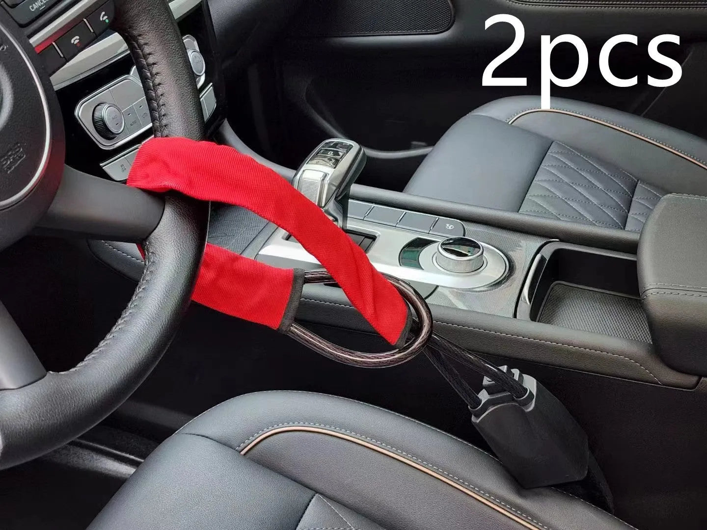 Red iron car steering wheel lock with wire rope, shown on a GM vehicle steering wheel.