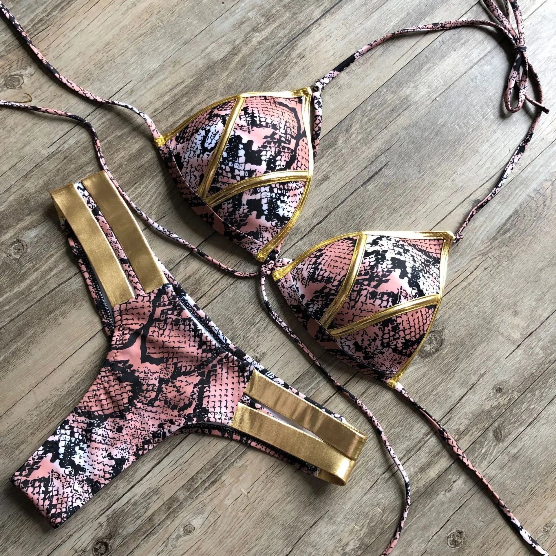 Women's bronzing bikini top and bottom set on a mannequin, showing adjustable straps.