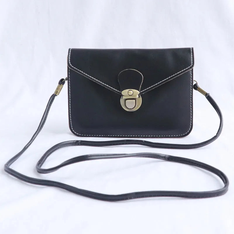 Soft surface PU messenger bag in wine red with a flap closure and metal lock detail.