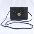 Soft surface PU messenger bag in wine red with a flap closure and metal lock detail.