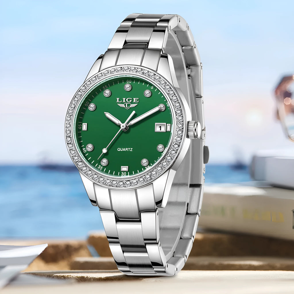 Silver stainless steel ladies watch with diamond-encrusted bezel and round blue dial.