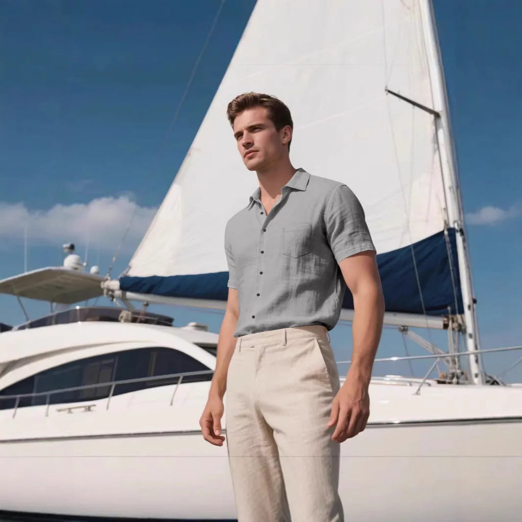 Man wearing a loose-fit light blue linen short-sleeved shirt in a casual setting.